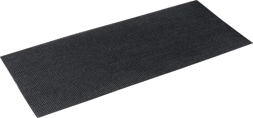 Pajarito_Dummy_Abrasive mesh grit_037053_037021_037043_2021-02 Rectangular black anti-slip mat photographed at a slight angle on a white background. The mat is thin and flat with a densely textured, pebble-like surface composed of small raised bumps in a regular pattern, likely made of rubber or a heavy-duty synthetic material. It appears flexible and durable, suitable for use as an entrance mat, protective underlay or anti-slip surface in high-traffic areas; the edges are straight and the color is a uniform dark charcoal to black.