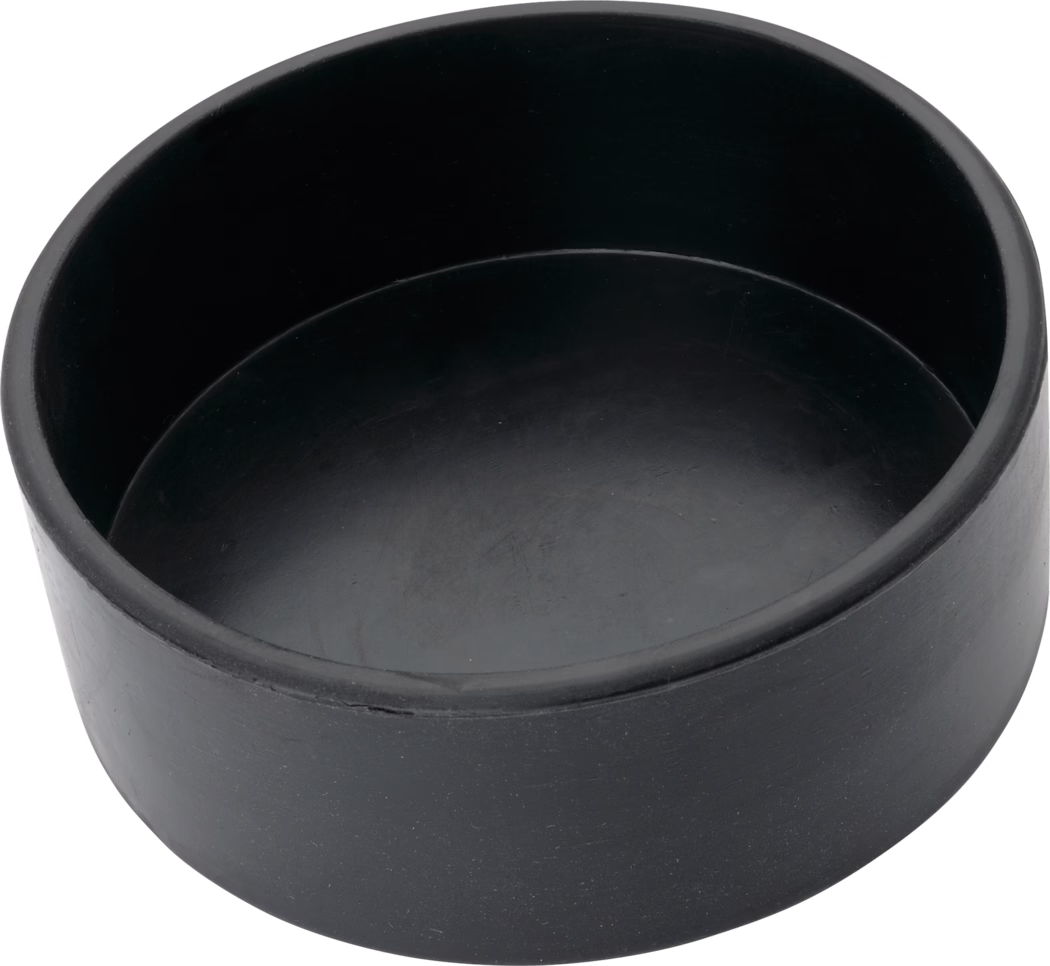 A round black rubber end cap or protective plug with a shallow cylindrical, cup-like shape, smooth matte surface with faint scuff marks, photographed from a top-side angle on a white background.