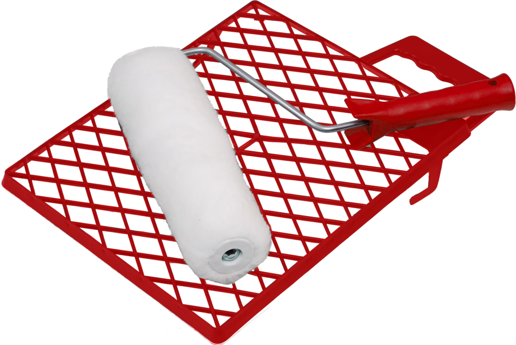 A white paint roller with a soft nap positioned diagonally on a red plastic paint grid/tray insert; the roller has a metal frame and a red handle, and the red grid features a diamond lattice pattern for removing excess paint. The background is white and the isolated composition clearly shows the roller cover fibers, the metal arm, and the textured red plastic grid.